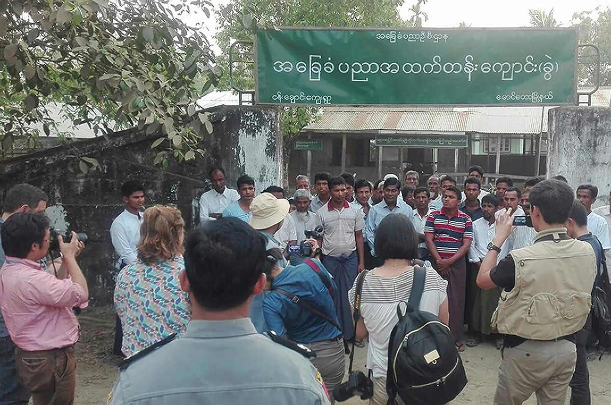 This handout photo taken on March 17, 2018, and released by Myanmar News Agency on April 3, 2018, shows a group of foreign journalists interviewing Muslim Rohingya residents during a government controlled trip in Maungdaw, near the Myanmar-Bangladesh bord