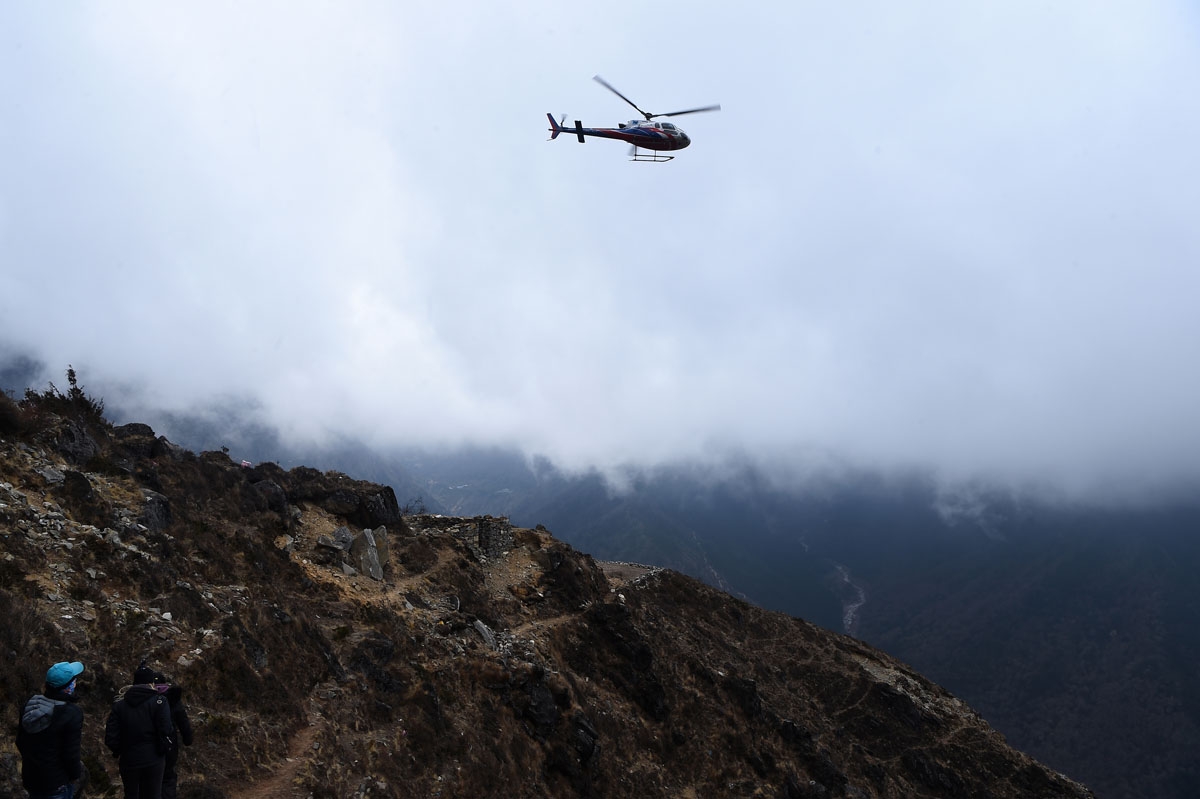 A helicopter comes in to land at Mong La village near Namche Bazar, April 17, 2018.
