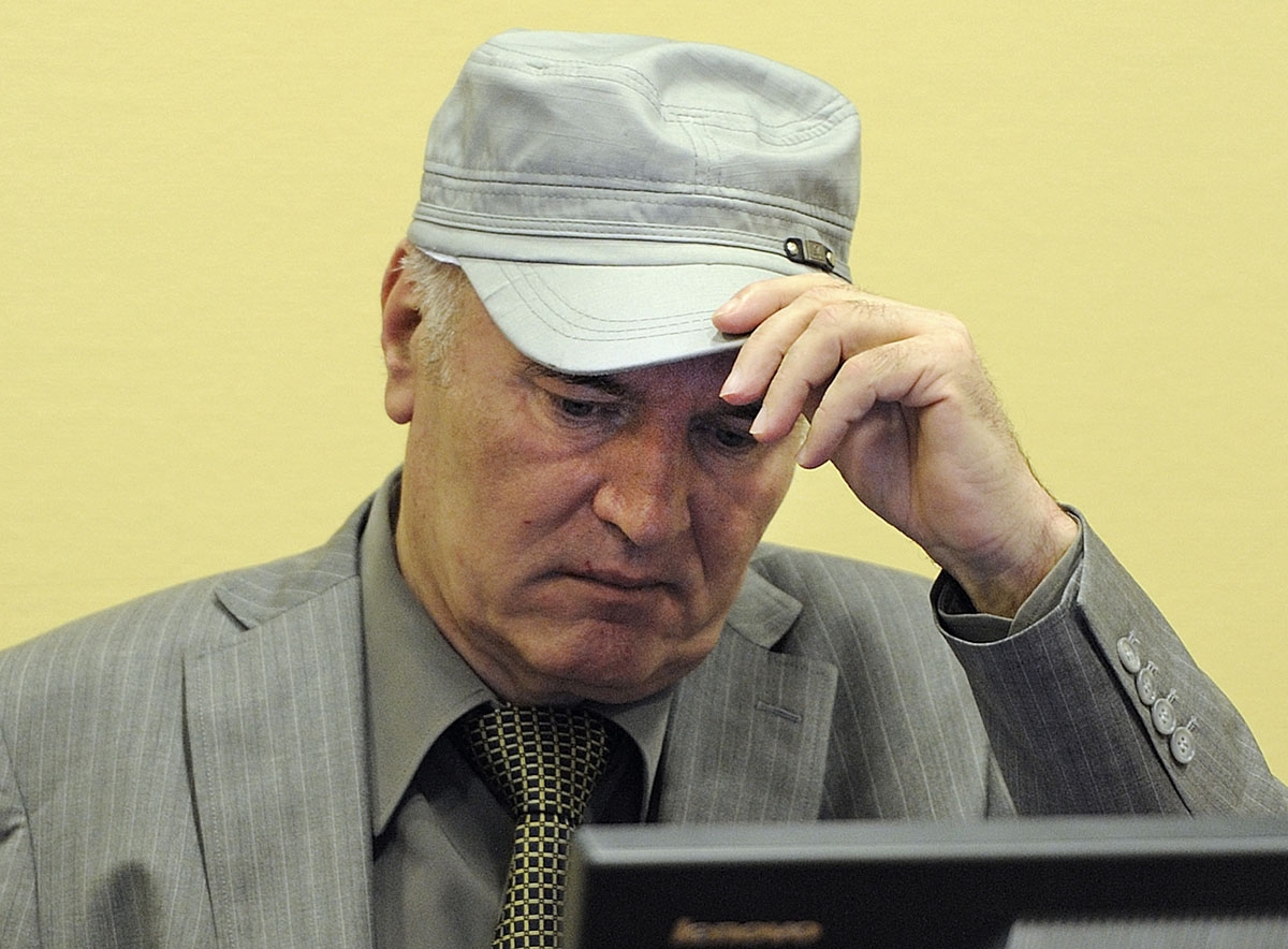Wartime Bosnian Serb army chief Ratko Mladic adjusts his cap in the court during his initial appearance at UN war crimes tribunal in The Hague, Netherlands, on June 3, 2011