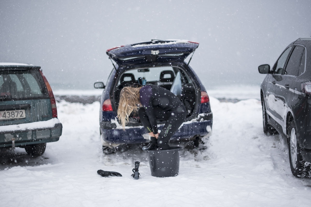 Emilie Klerud from Norway takes off her wetsuit after a surfing session, on March 11, 2018, in Unstad, northern Norway, Lofoten islands, within the Arctic Circle.