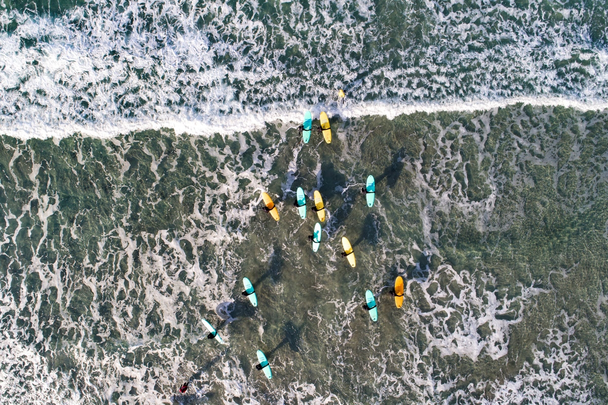 Surfers attend a a surfing course on March 10, 2018 in Unstad, northern Norway, Lofoten islands, within the Arctic Circle as air temperature drops minus 13°C and water temperature above 4°C.
