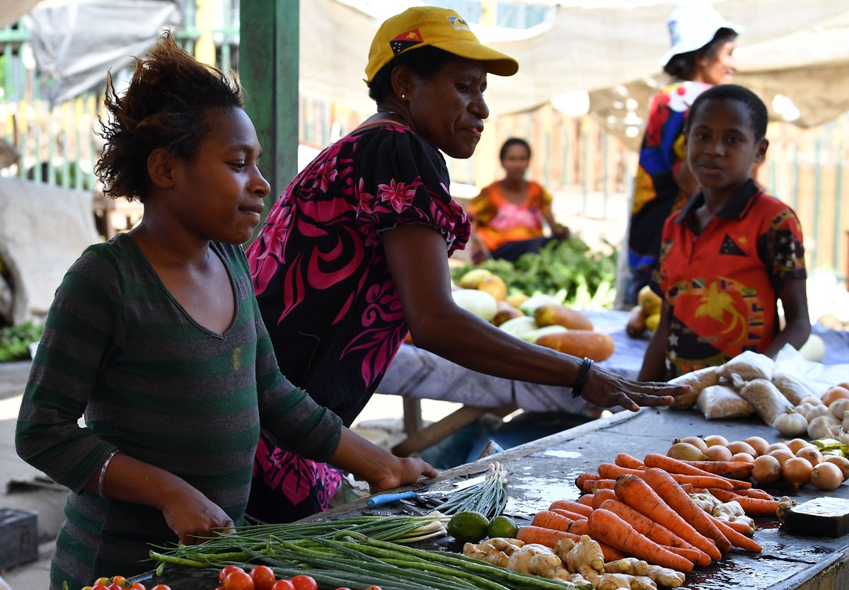 Vendors sell vegetables at a women's only makeshift market on the outskirts of Port Moresby on November 19, 2018, one day after the Asia-Pacific Economic Cooperation (APEC) Summit.