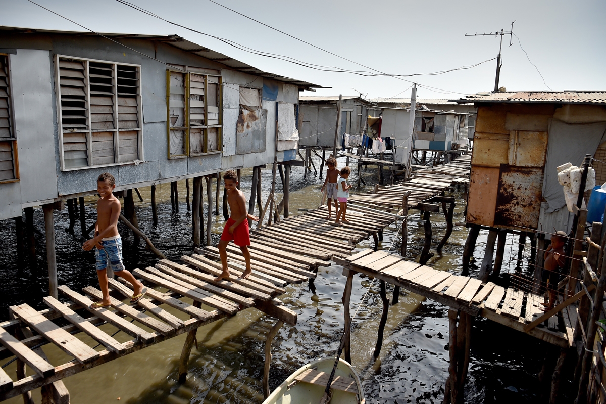 Residents are seen in the village of Hanuabada, one of only two remaining stilt villages in Port Moresby on November 15, 2018 ahead of the Asia-Pacific Economic Cooperation (APEC) summit.