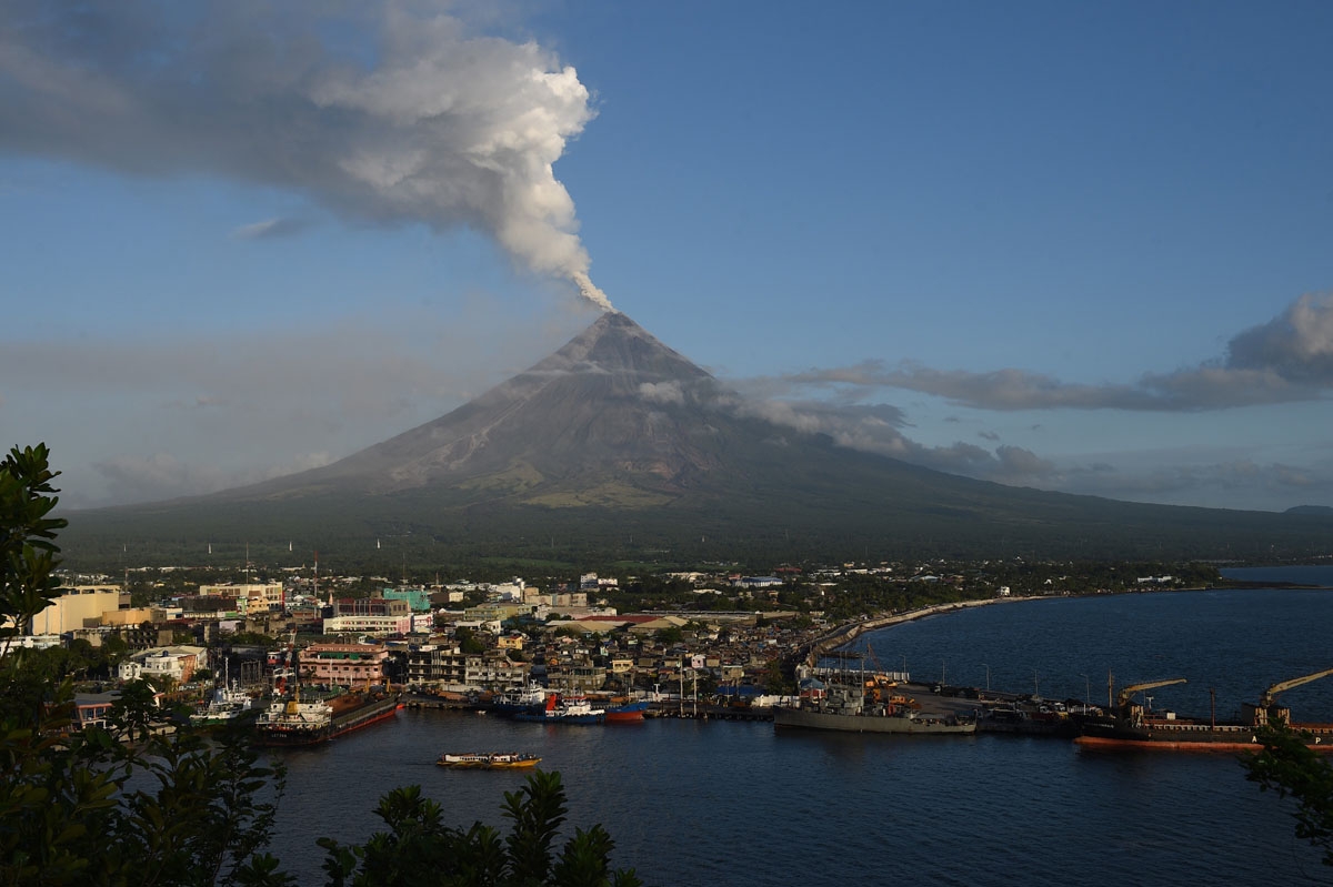 Ash spews from the Mayon volcano, seen from the Philippine city of Legazpi in Albay province, south of Manila early on January 31, 2018.