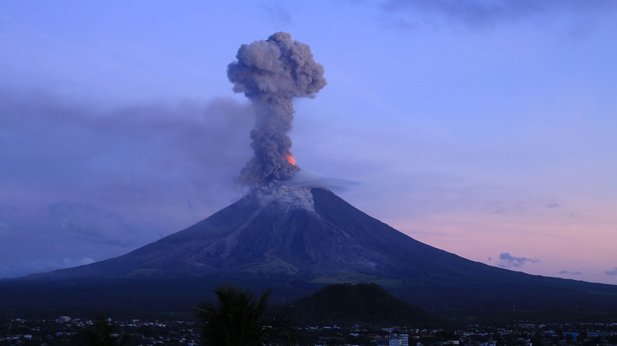 This photo taken from a drone shows a column of ash shooting up from the Mayon volcano as it continues to erupt, seen from the city of Legazpi in Albay province, south of Manila on January 24, 2018.