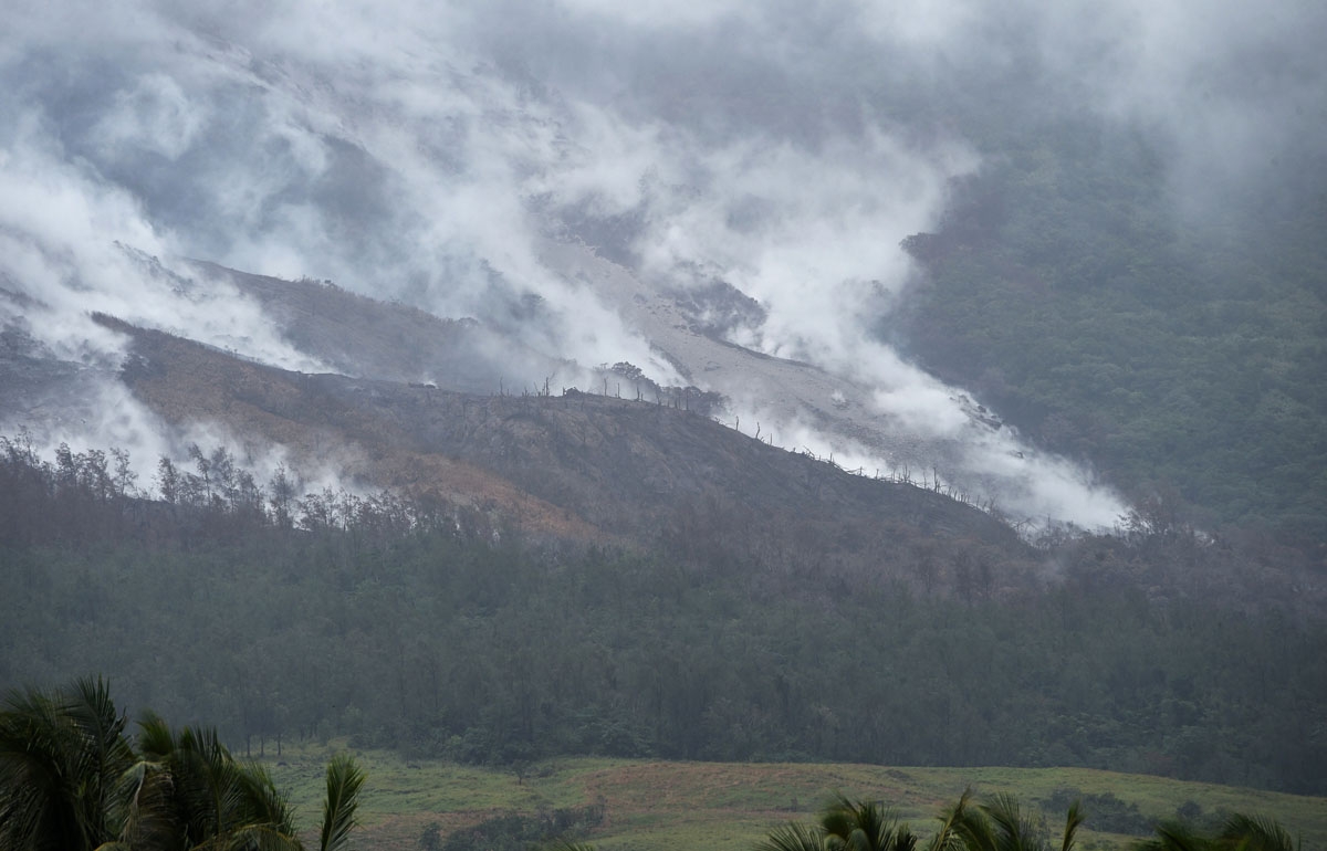 Steaming lava and pyroclastic deposits are seen at the foot of the Mayon volcano, from the town of Daraga in Albay province on January 28, 2018, as heavy rains pounds areas near the volcano.