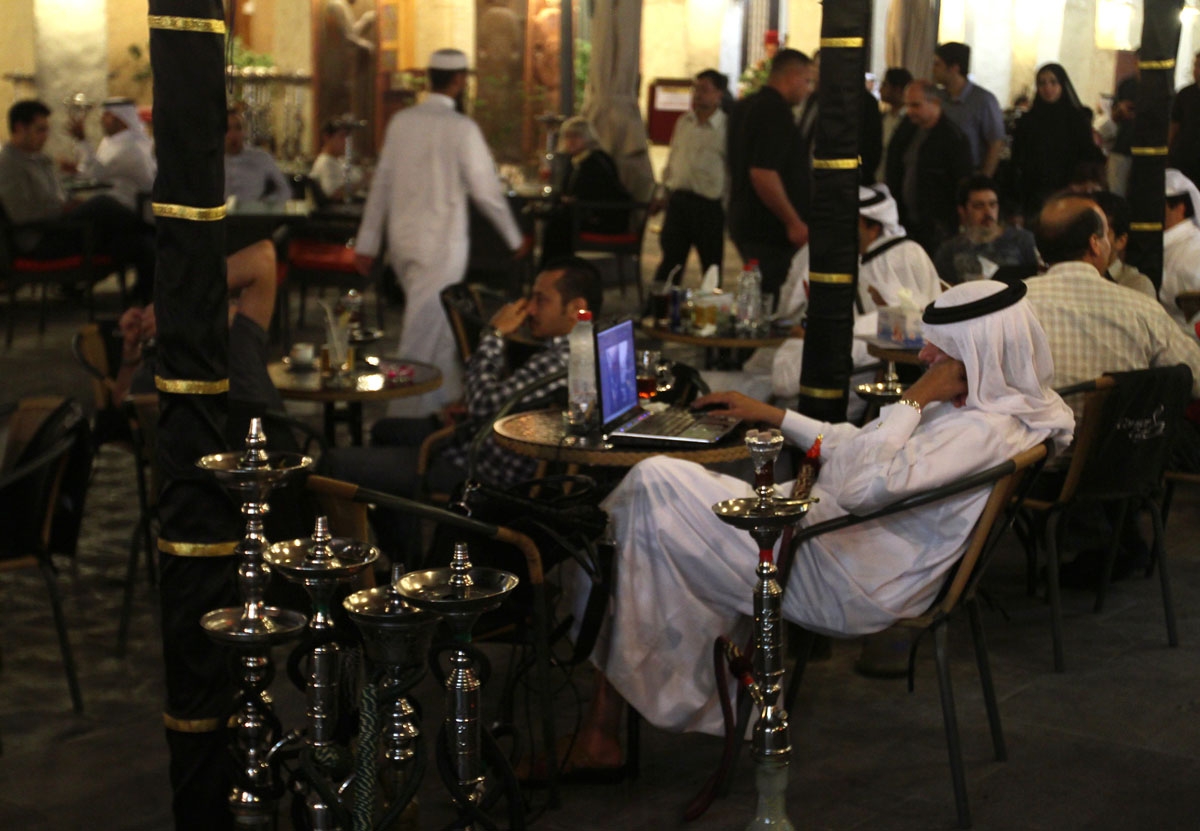 A Qatari man works on his laptop at a cafe at the Souq Waqif market in the old city of Doha late on March 10, 2010.