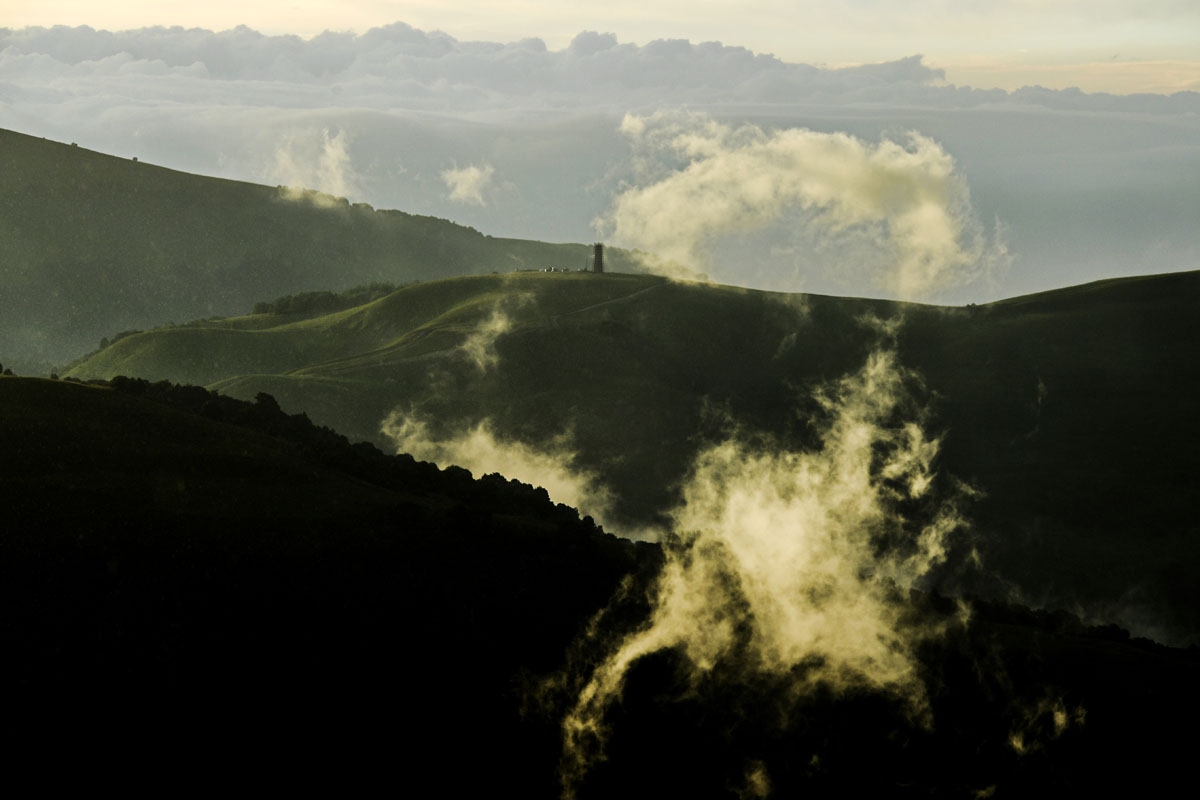 A photo shows clouds in the foreground near a historical Chechen guard tower under construction outside the village of Vedeno, about 60 km from Grozny, on July 25, 2017.