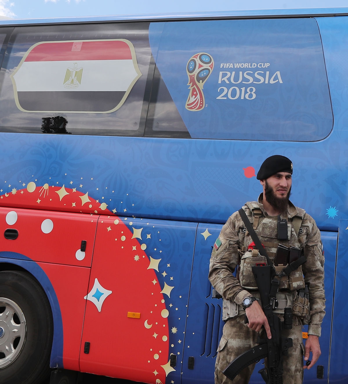 A soldier patrols around the Egyptian team bus at Grozny International Airport on June 10, 2018, ahead of the Russia 2018 World Cup. / AFP PHOT