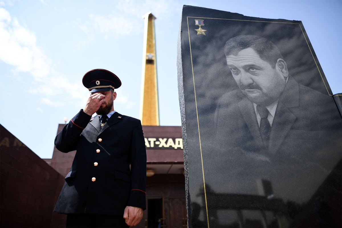 A Chechen police officer gestures as he stands guard in front of the memorial for Akhmad Kadyrov, the father of current Chechen President Ramzan Kadyrov, in Grozny on July 25, 2017.