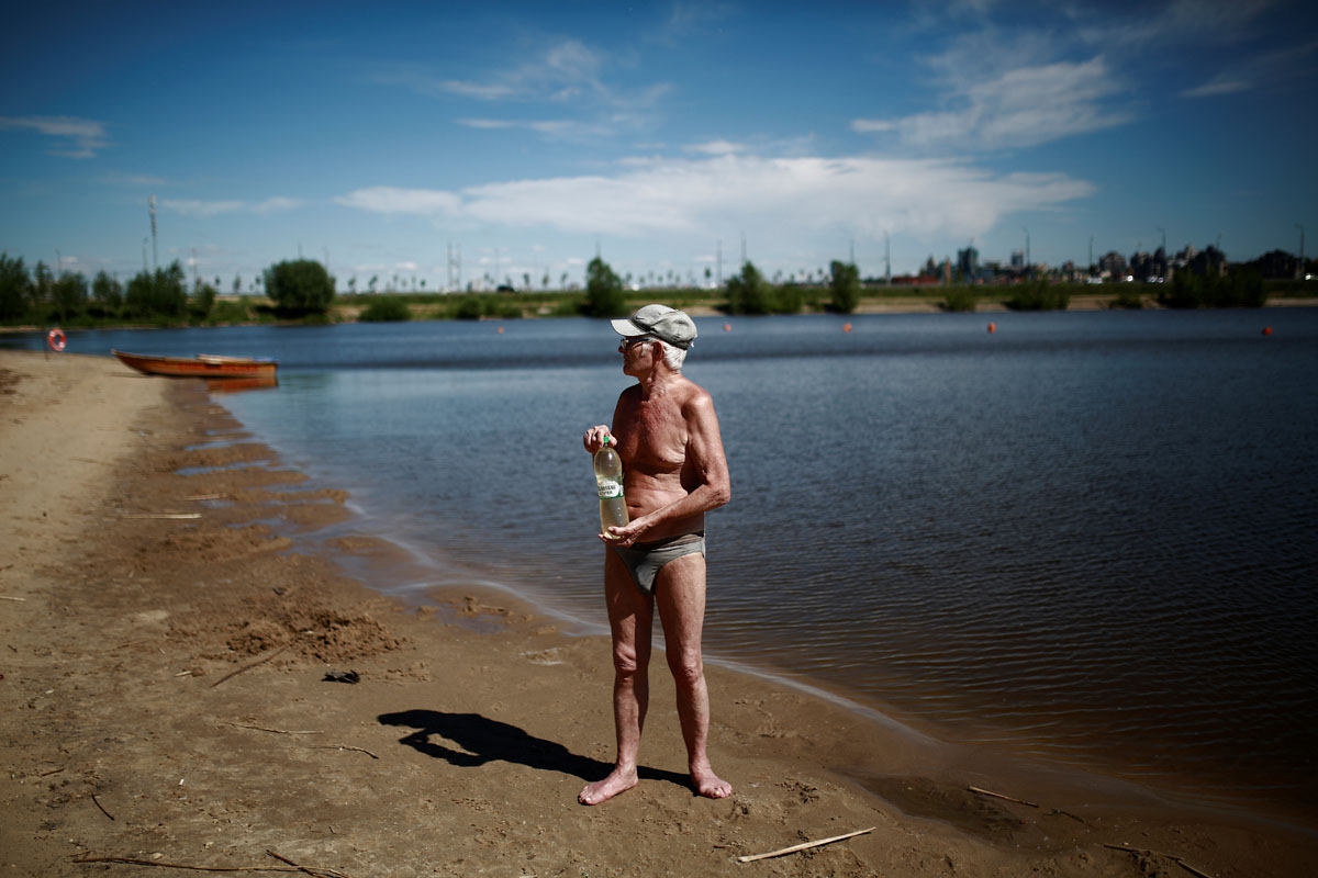 A man stands on the beach by the Volga river in Kazan on June 17, 2018 during the Russia 2018 World Cup football tournament.