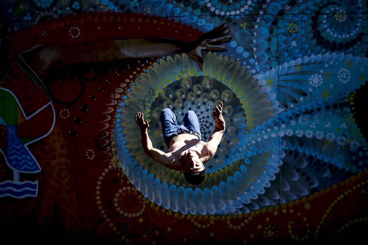 A man does a backflip in an urban gym court in Kazan on June 17, 2018 during the Russia 2018 World Cup football tournament.