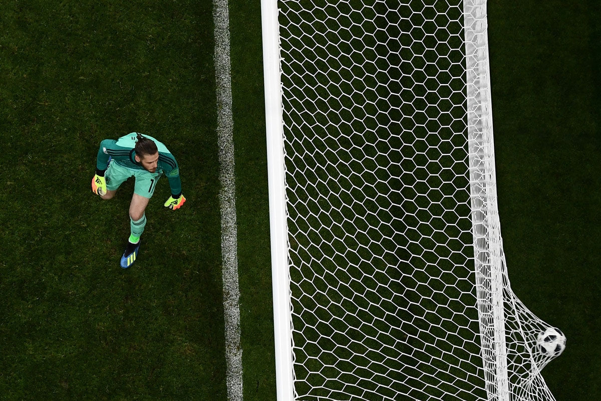 Spain's goalkeeper David De Gea concedes the third goal during the Russia 2018 World Cup Group B football match between Portugal and Spain at the Fisht Stadium in Sochi on June 15, 2018. / AFP PHOTO / Jewel SAMAD /