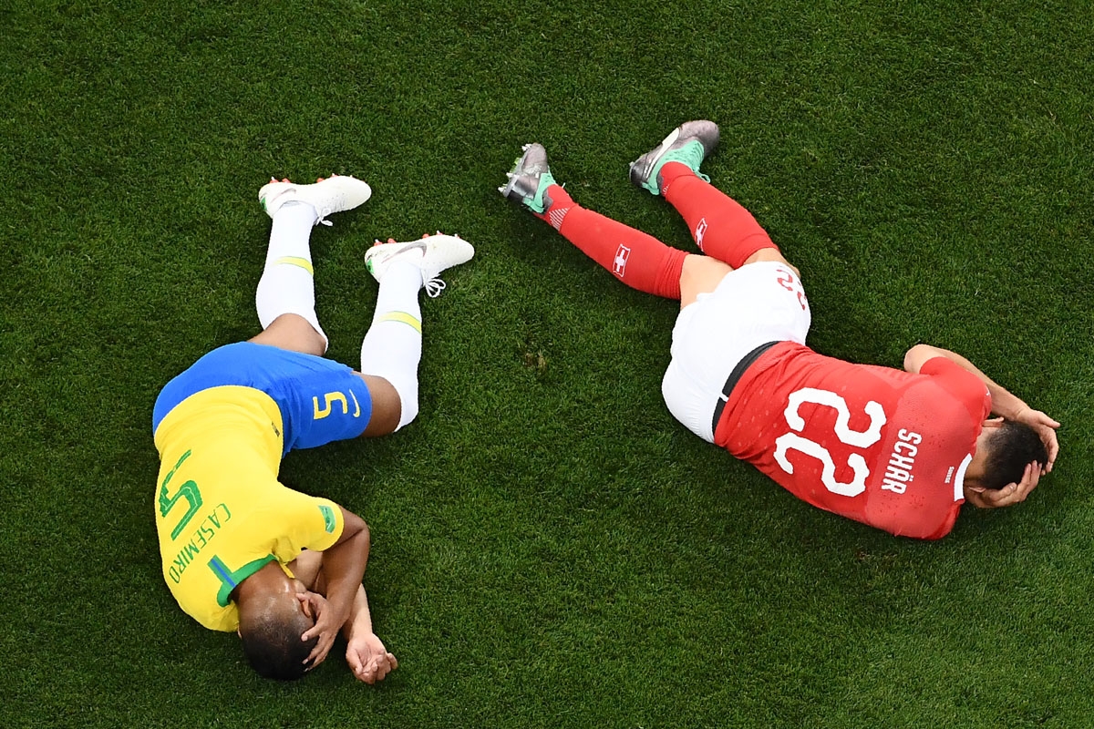 Brazil's midfielder Casemiro (L) and Switzerland's defender Fabian Schaer react after a shock during the Russia 2018 World Cup Group E football match between Brazil and Switzerland at the Rostov Arena in Rostov-On-Don on June 17, 2018. / AFP PHOTO