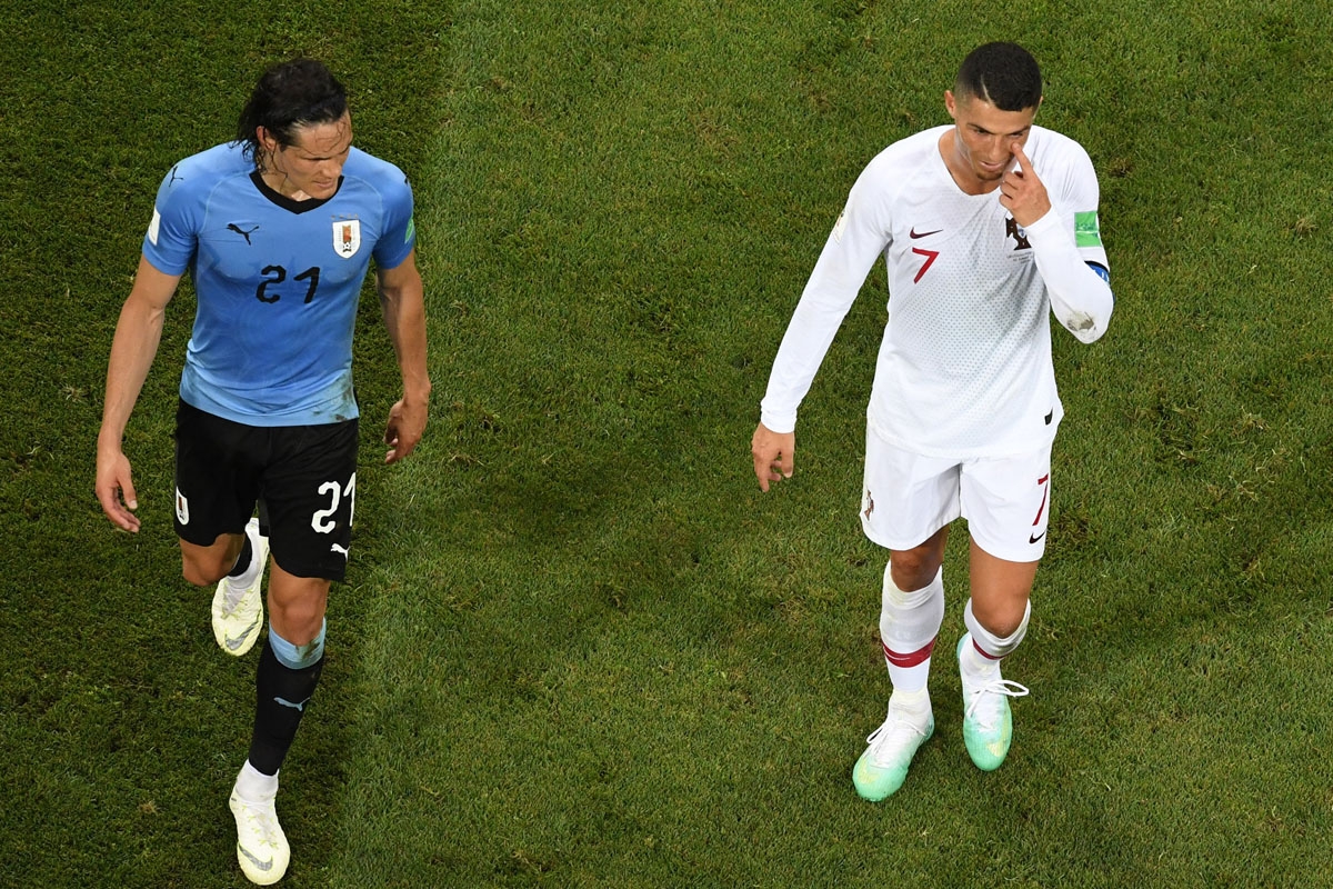 Portugal's forward Cristiano Ronaldo (R) gestures next to Uruguay's forward Edinson Cavani during the Russia 2018 World Cup round of 16 football match between Uruguay and Portugal at the Fisht Stadium in Sochi on June 30, 2018. /