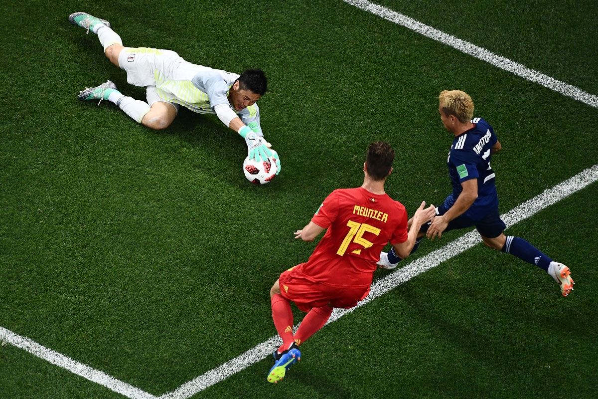 Japan's goalkeeper Eiji Kawashima (L) stops a shot on goal by Belgium's defender Thomas Meunier (C) during the Russia 2018 World Cup round of 16 football match between Belgium and Japan at the Rostov Arena in Rostov-On-Don on July 2, 2018.