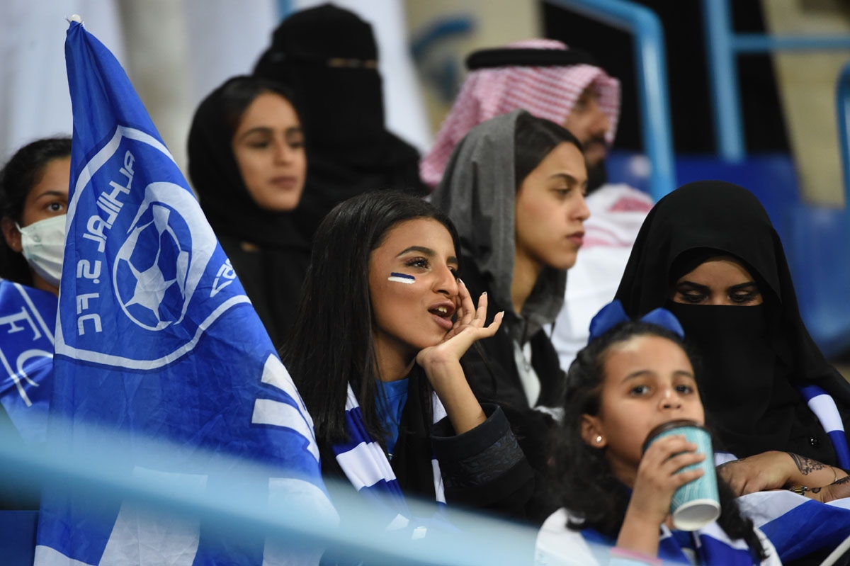 Saudi female fans watch the AFC Champions League football match between Saudi al-Hilal and Qatari al-Rayyan at the King Saudi University stadium in Riyadh on March 6, 2018.