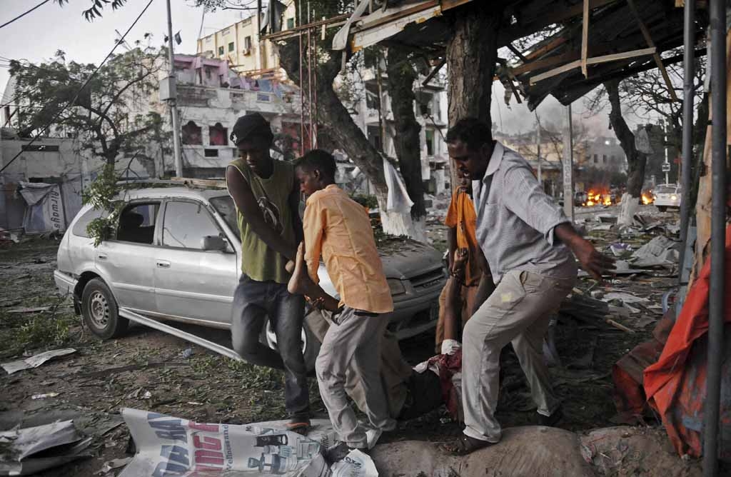 A victim is carried away from the scene of a terror attack at the Ambassador Hotel, after a car bomb exploded on June 1, 2016 at a top Mogadishu hotel that houses several MPs, killing several people, and followed by a gun battle. A victim is carried away from the scene of a terror attack at the Ambassador Hotel, after a car bomb exploded on June 1, 2016 at a top Mogadishu hotel that houses several MPs, killing several people, and followed by a gun battle.