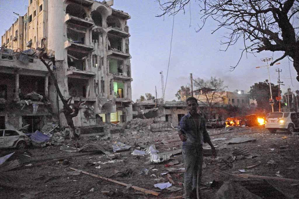 A man stands next to the Ambassador Hotel, after Somalia's Al-Qaeda-linked Shabaab on June 1, 2016, launched a deadly attack on a top Mogadishu hotel popular with MPs, setting off a car bomb and fighting security forces inside the complex. A man stands next to the Ambassador Hotel, after Somalia's Al-Qaeda-linked Shabaab on June 1, 2016, launched a deadly attack on a top Mogadishu hotel popular with MPs, setting off a car bomb and fighting security forces inside the complex.
