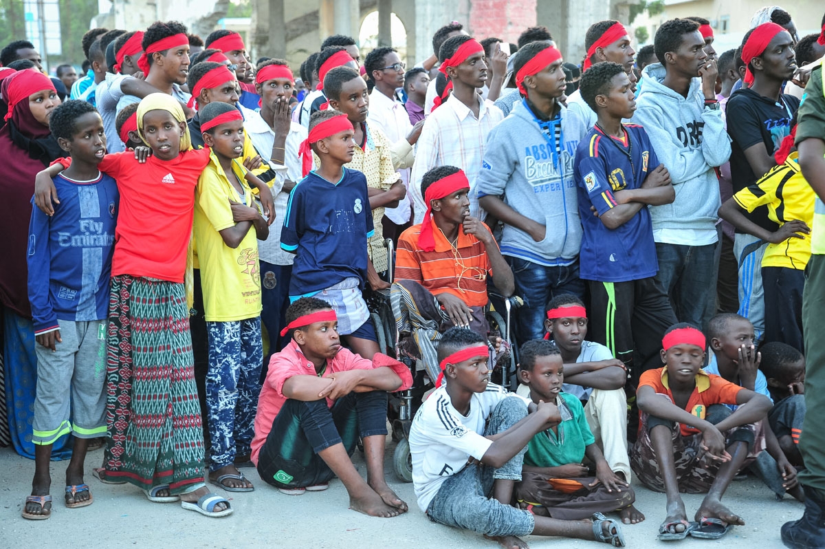 People wear red headbands as a sign of anger as they protest against the deadly bomb attack in Mogadishu on October 15, 2017, after a truck bomb exploded outside of the Safari Hotel on a busy road junction, levelling buildings and leaving many vehicles in