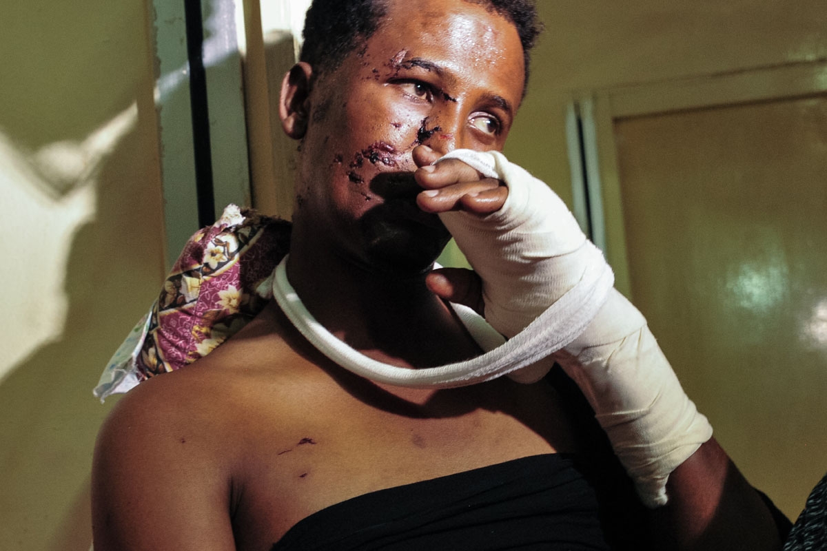 Ibrahim Mohamed, a survivor of the last deadly truck bomb attack in the city centre, speaks to media as he sits on his bed at the Medina hospital in Mogadishu, on October 16, 2017.