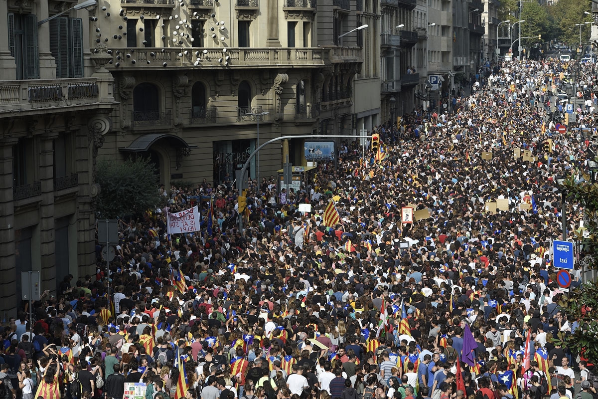 Protesters gather outside the Spanish police headquarters in Barcelona as part of a general strike in Catalonia called by Catalan unions on October 3, 2017.