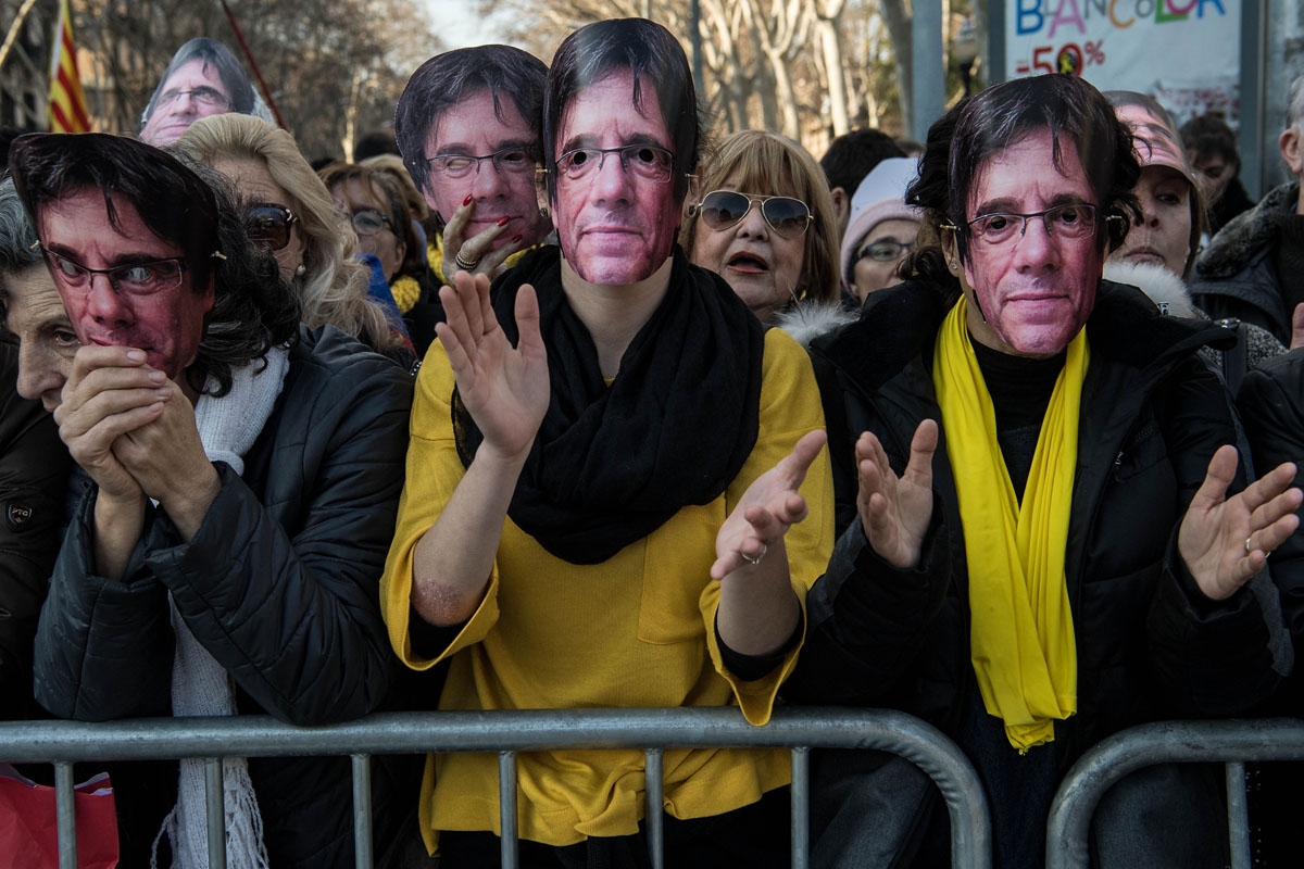 BARCELONA, SPAIN - JANUARY 30: Demonstrators wear cut-out masks of the former Catalan President, Carles Puigdemont as they take part in a protest on January 30, 2018 in Barcelona, Spain. T