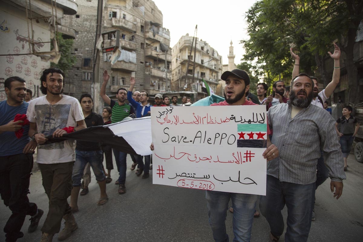 Syrians shout slogans during an anti-regime protest in the rebel-held Bustan al-Qasr district in eastern Aleppo on May 5, 2016