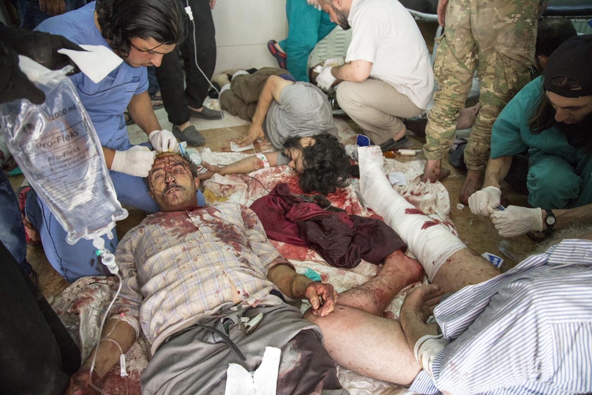 Syrians receive treatment at a make-shift hospital following air strikes on rebel-held eastern areas of Aleppo on September 24, 2016.