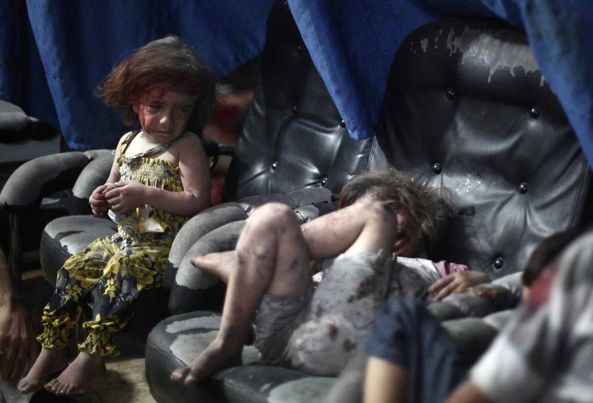 A wounded Syrian child cries looking on at another wounded girl, as they wait for treatment, at a makeshift hospital in the rebel-held town of Douma near Damascus on September 11, 2014, after reported airstrikes by Syrian government forces. A wounded Syrian child cries looking on at another wounded girl, as they wait for treatment, at a makeshift hospital in the rebel-held town of Douma near Damascus on September 11, 2014, after reported airstrikes by Syrian government forces.