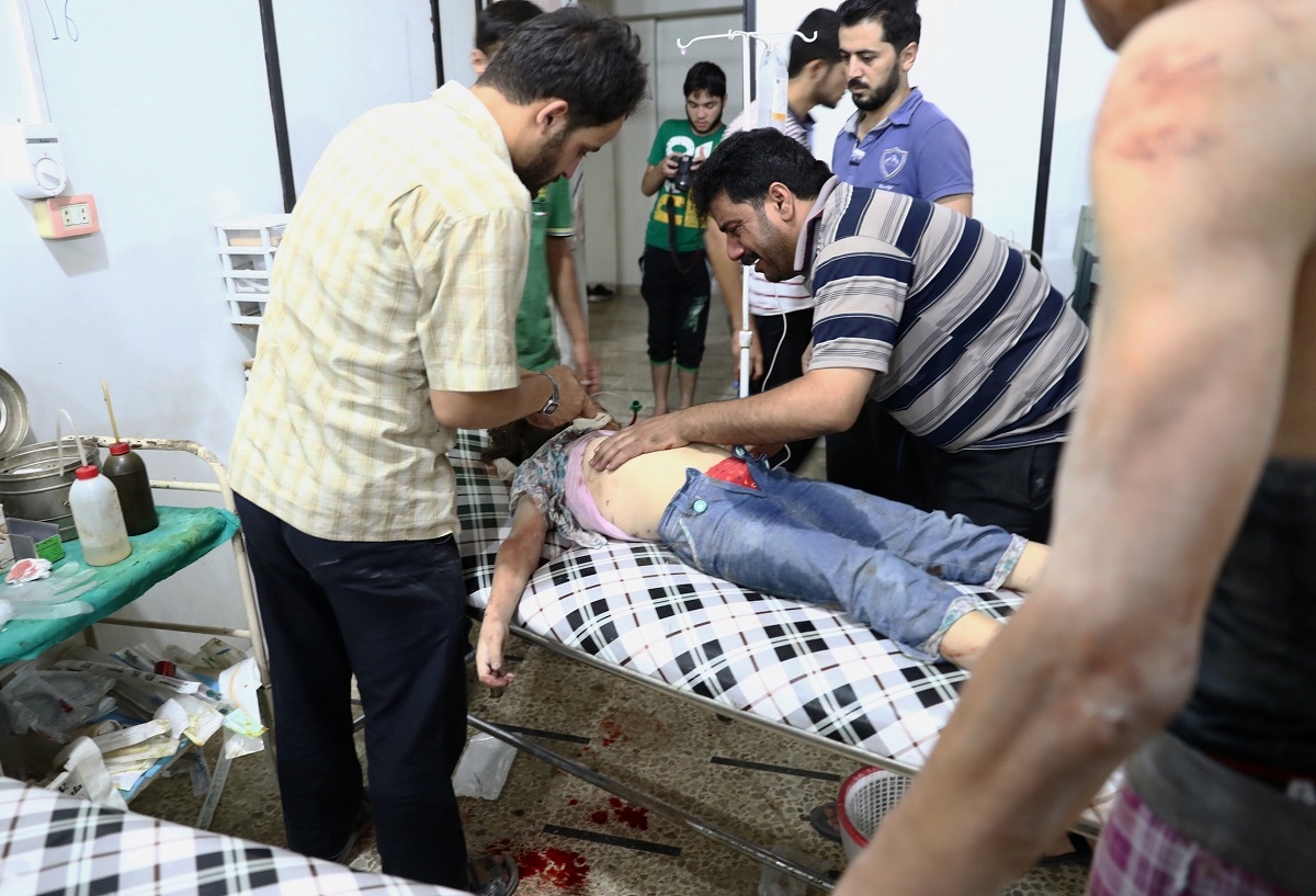 A Syrian man stands next to his daughter as she receives treatment at a makeshift hospital following a reported air stike on the rebel-held town of Douma, east of the capital Damascus, on August 23, 2016. A Syrian man stands next to his daughter as she receives treatment at a makeshift hospital following a reported air stike on the rebel-held town of Douma, east of the capital Damascus, on August 23, 2016.