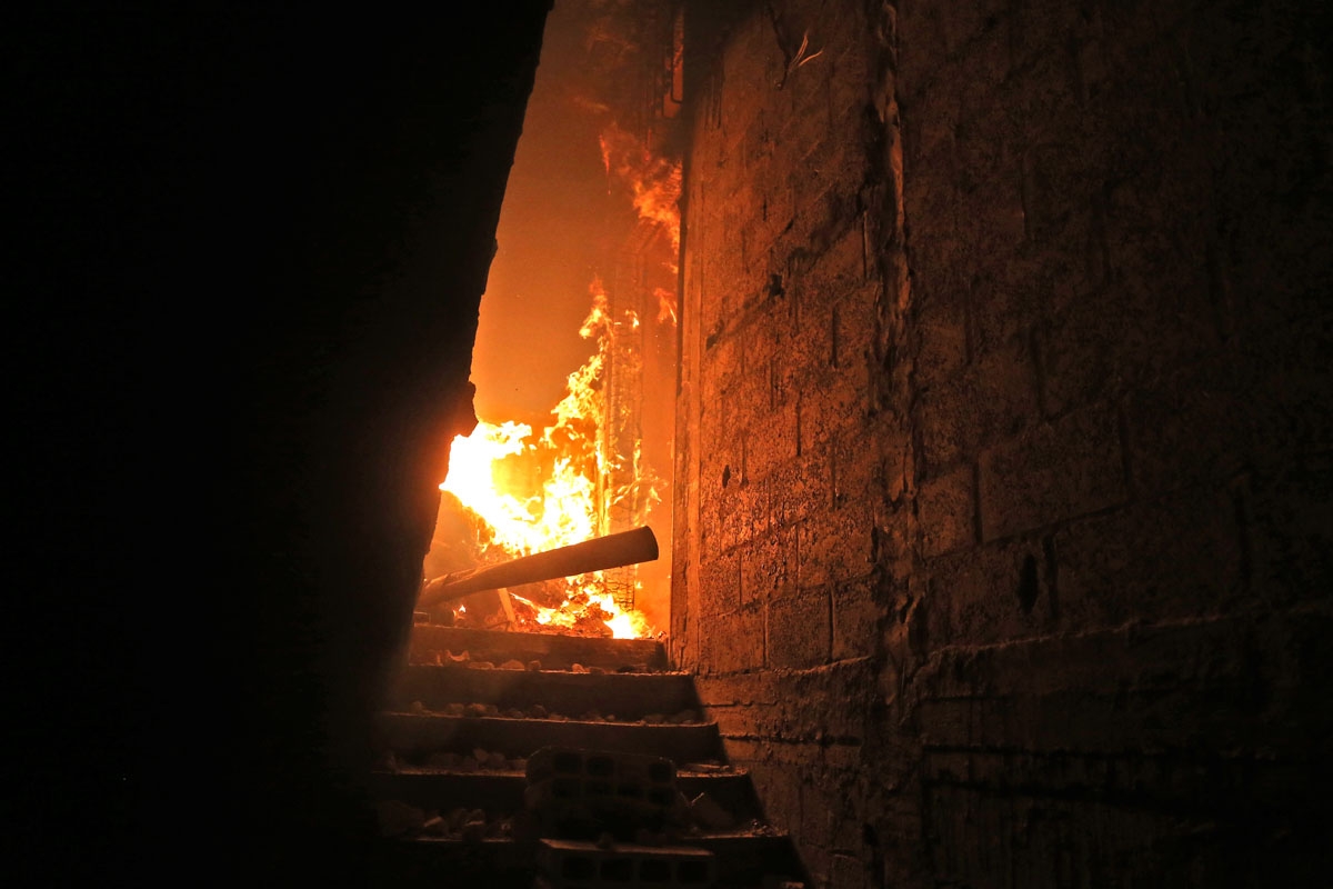 A building burns after reported government bombardment in Hammurieyeh, March 6, 2018.