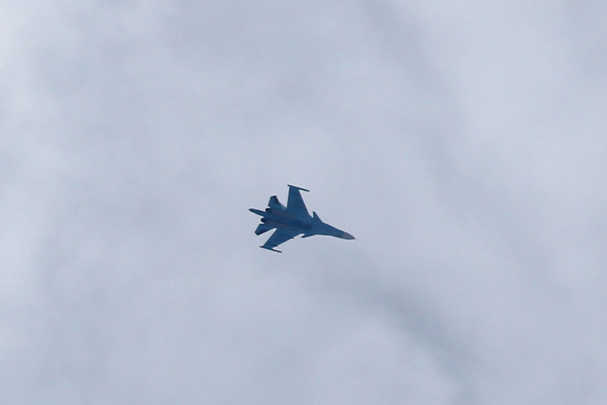 A picture taken on February 20, 2018 shows a Russian air force Sukhoi Su-34 fighter jet flying over the sky in the rebel-held town of Arbin, in the besieged Eastern Ghouta region on the outskirts of the capital Damascus.