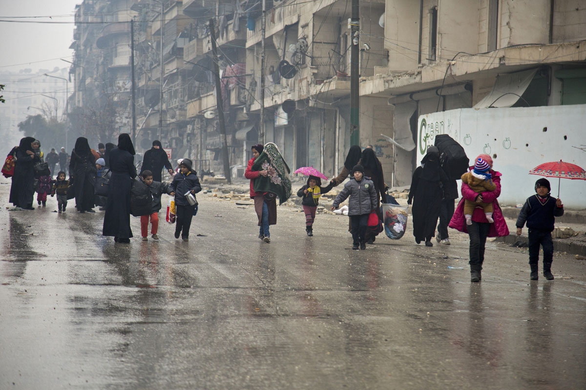 Syrians leave a rebel-held area of Aleppo towards the government-held side on December 13, 2016 during an operation by Syrian government forces to retake the embattled city. UN chief Ban Ki-moon expressed alarm over reports of atrocities against civilians