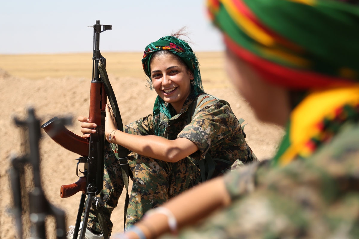Female fighters from the Kurdish People Protection Unit (YPG) take a break on the front line in the northeastern Syrian city of Hasakeh on September 4, 2015.