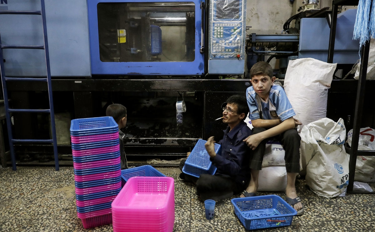 A Syrian employee works at a plastic factory in Aleppo's Kallase neighbourhood on July 5, 2017