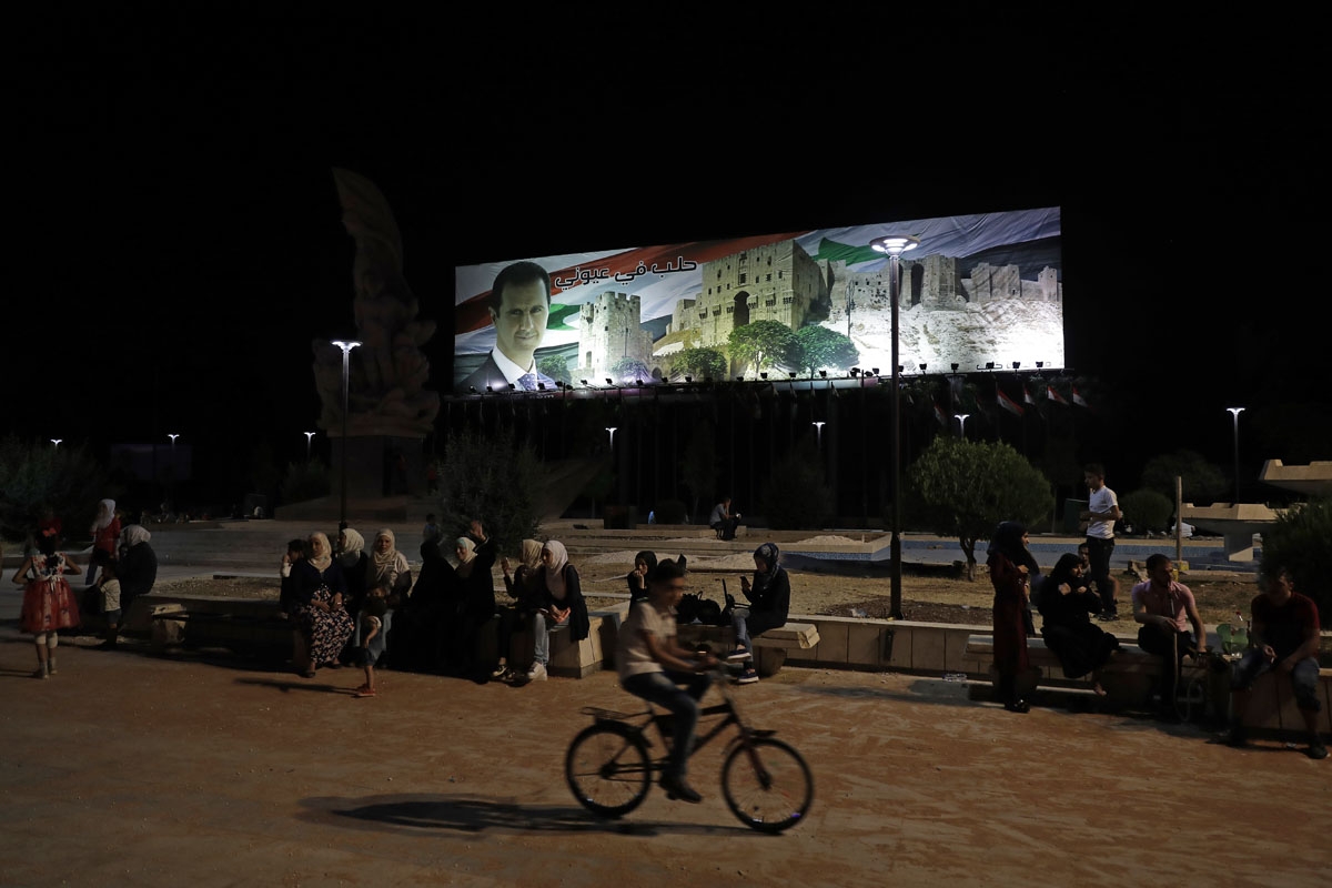 Syrians spend the evening in Aleppo's once sniper-controlled square of Saadallah al-Jabiri on July 5, 2017.