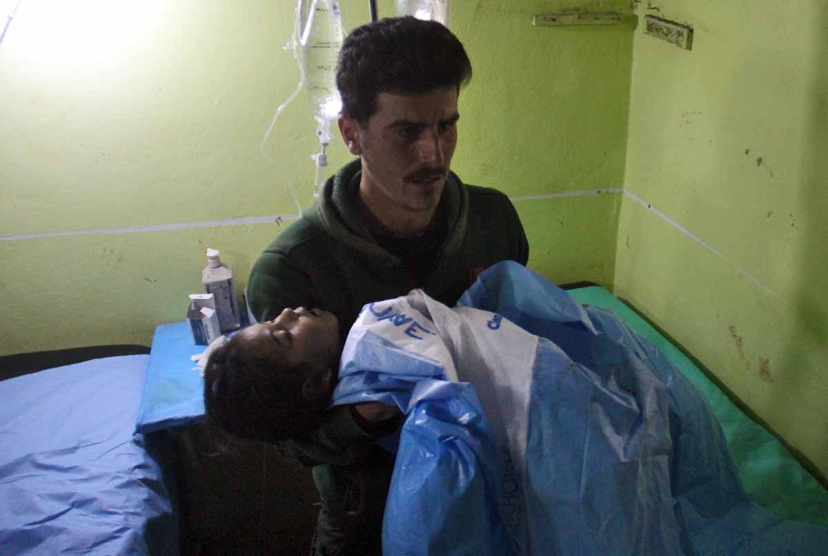 An unconscious Syrian child is carried at a hospital in Khan Sheikhun, a rebel-held town in the northwestern Syrian Idlib province, following a suspected toxic gas attack on April 4, 2017.