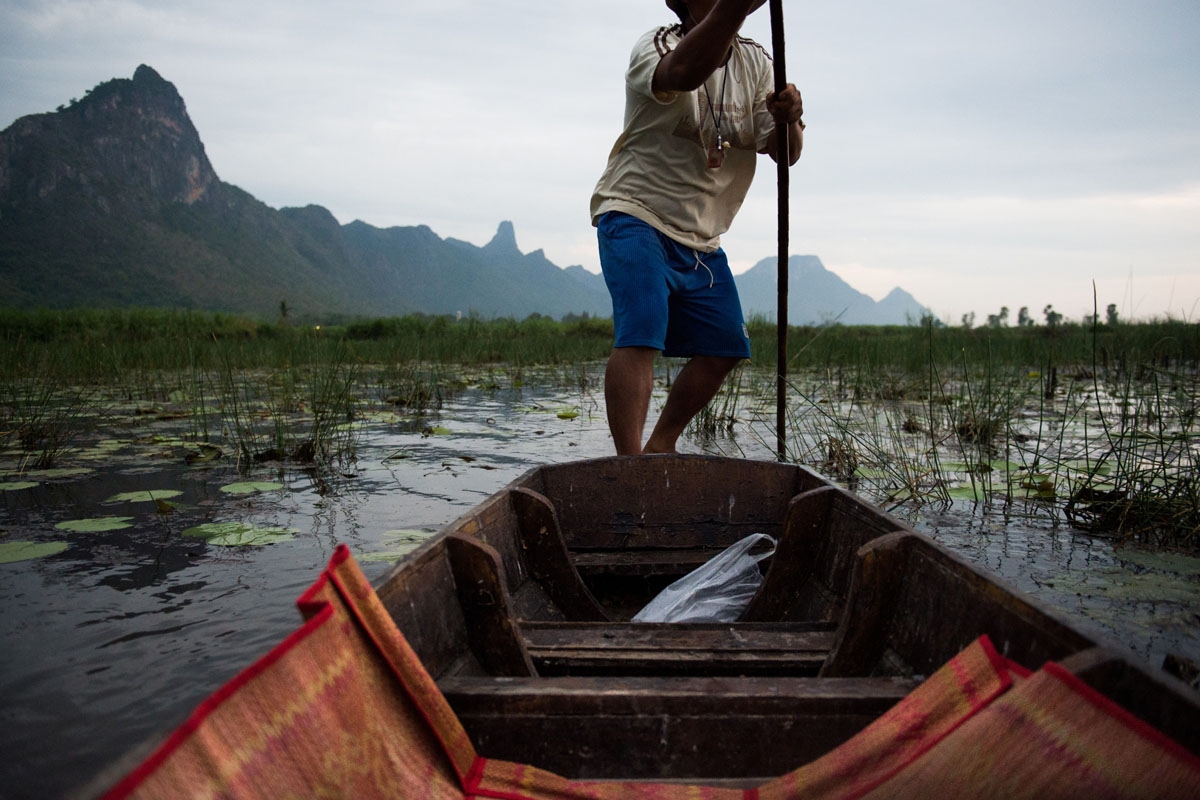 In this photograph taken on May 5, 2017, a local canoe owner makes his way through a lake in the Khao Sam Roi Yot national park in southern Thailand.
