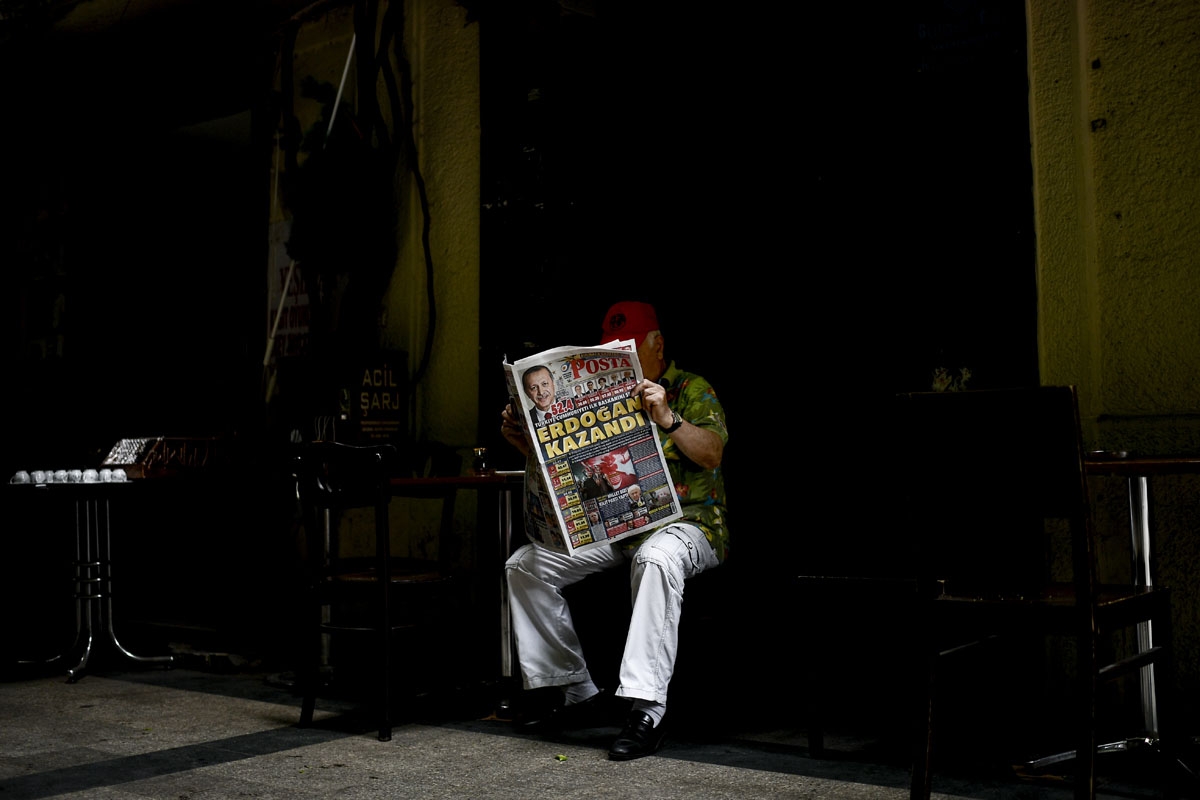 A man reads a newspaper a day after the Presidential and parliamentary elections in Istanbul on June 25, 2018.