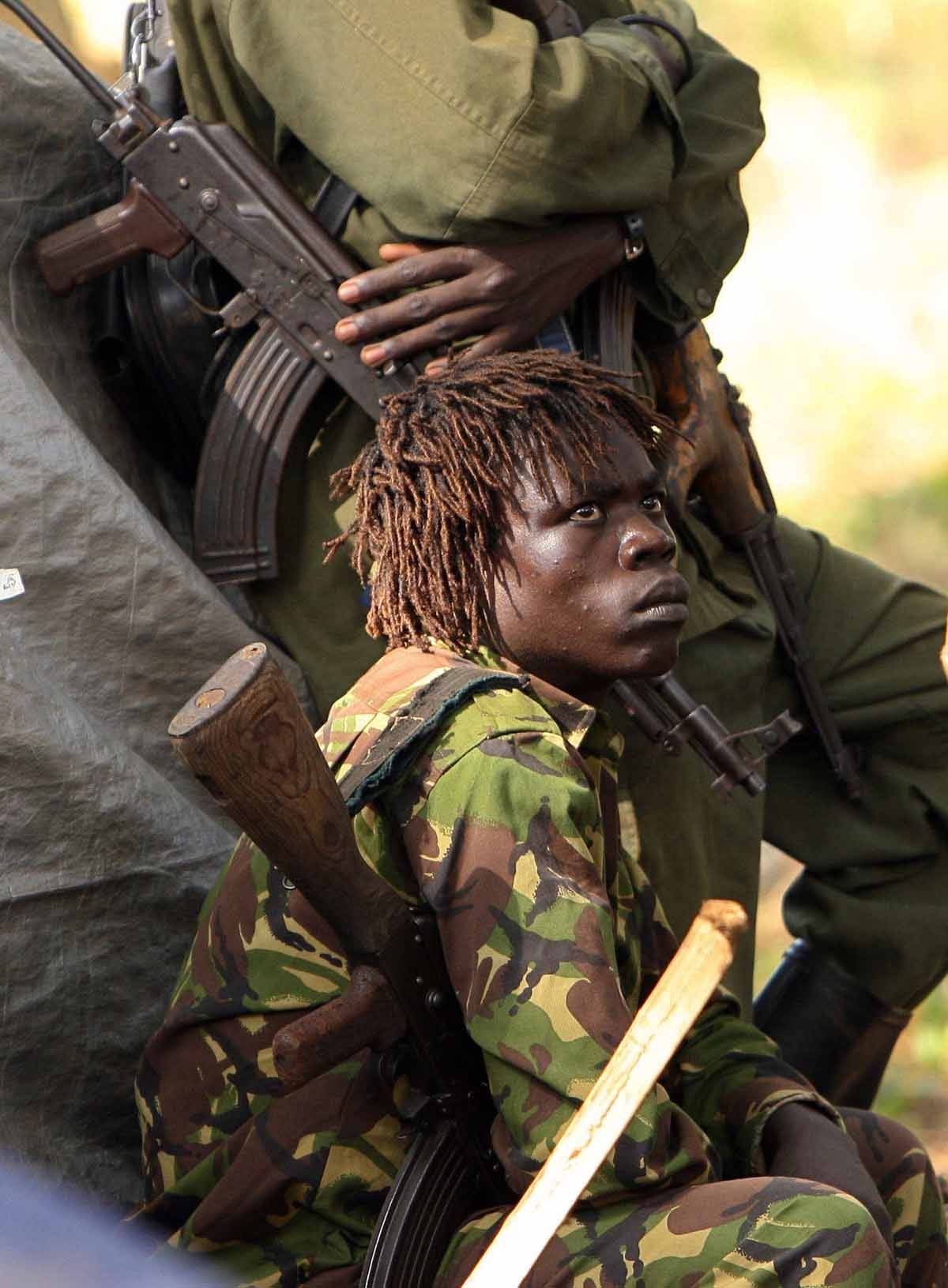 An armed fighter of the Lord's Resistance Army (LRA) looks at a fellow fighter 12 November 2006 during a meeting between the rebel group's leadership and United Nations Emergency Relief coordinator Jan Egeland in Ri-Kwamba, southern Sudan. An armed fighter of the Lord's Resistance Army (LRA) looks at a fellow fighter 12 November 2006 during a meeting between the rebel group's leadership and United Nations Emergency Relief coordinator Jan Egeland in Ri-Kwamba, southern Sudan.