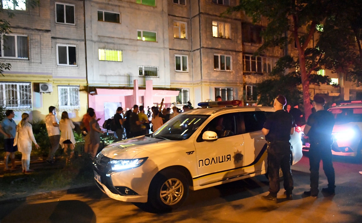 Journalists and neighbours gather at the entrance of the building where journalist Arkadi Babchenko was alleged to have been shot dead in his apartment on May 29, 2018.