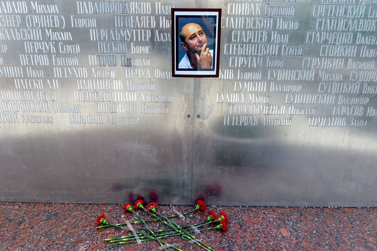 Flowers lay under a picture of the 41-year-old anti-Kremlin reporter Arkady Babchenko on the memorial wall of Moscow's journalists house in Moscow on May 30, 2018.