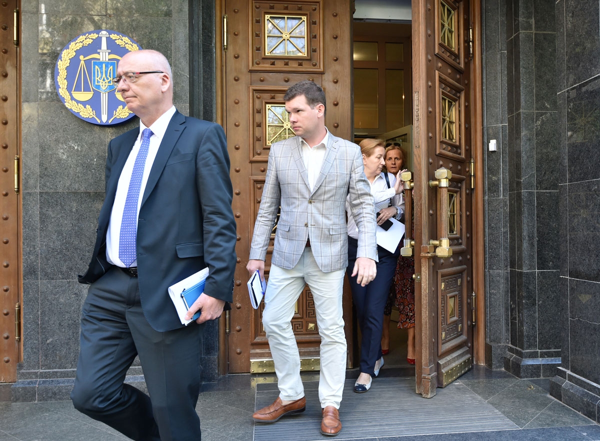 A group of diplomats from Germany, Canada, the United States, France, Britain, Italy and Japan, leave a meeting at Ukraine's General Prosecutor office on June 1, 2018 to brief them on Kiev's decision to stage a contract-style killing of Russian journalis