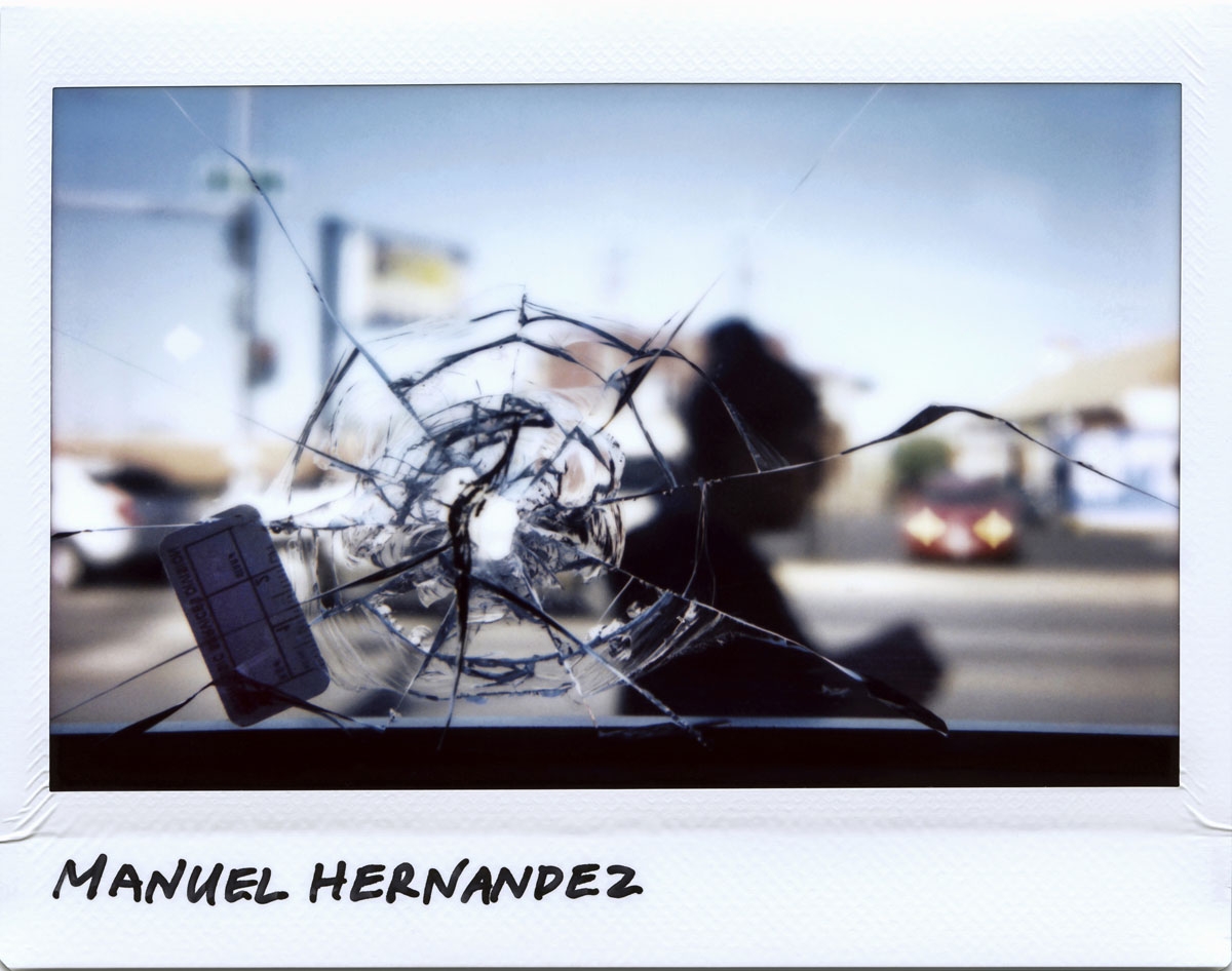 A person walks by a bullet hole in a restaurant window that is linked to the shooting of Manuel Hernandez, 30-year-old, taken at the 2700 block of West 51st Street in Chicago, Illinois on September 28, 2017. Hernandez was killed on September 21, 2017.