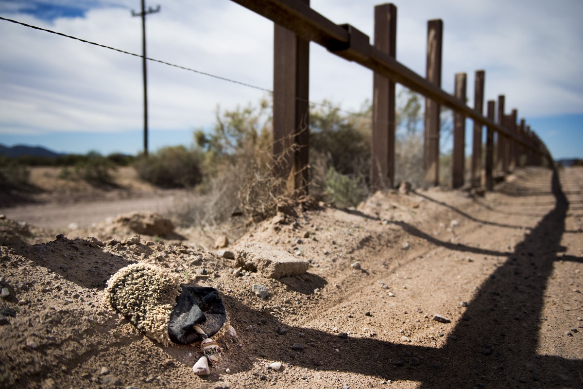 A slipper made of carpet fabric, used to wrap migrants shoes to hide foot tracks, lays next to the border fence outside Lukeville, Arizona, on February 16, 2017, on the US/Mexico border.