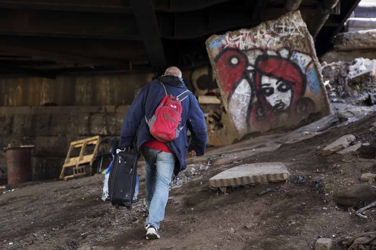 Steve, an addict, walks up to the street after getting high at a heroin encampment in the Kensington neighborhood of Philadelphia, Pennsylvania, on April 10, 2017.