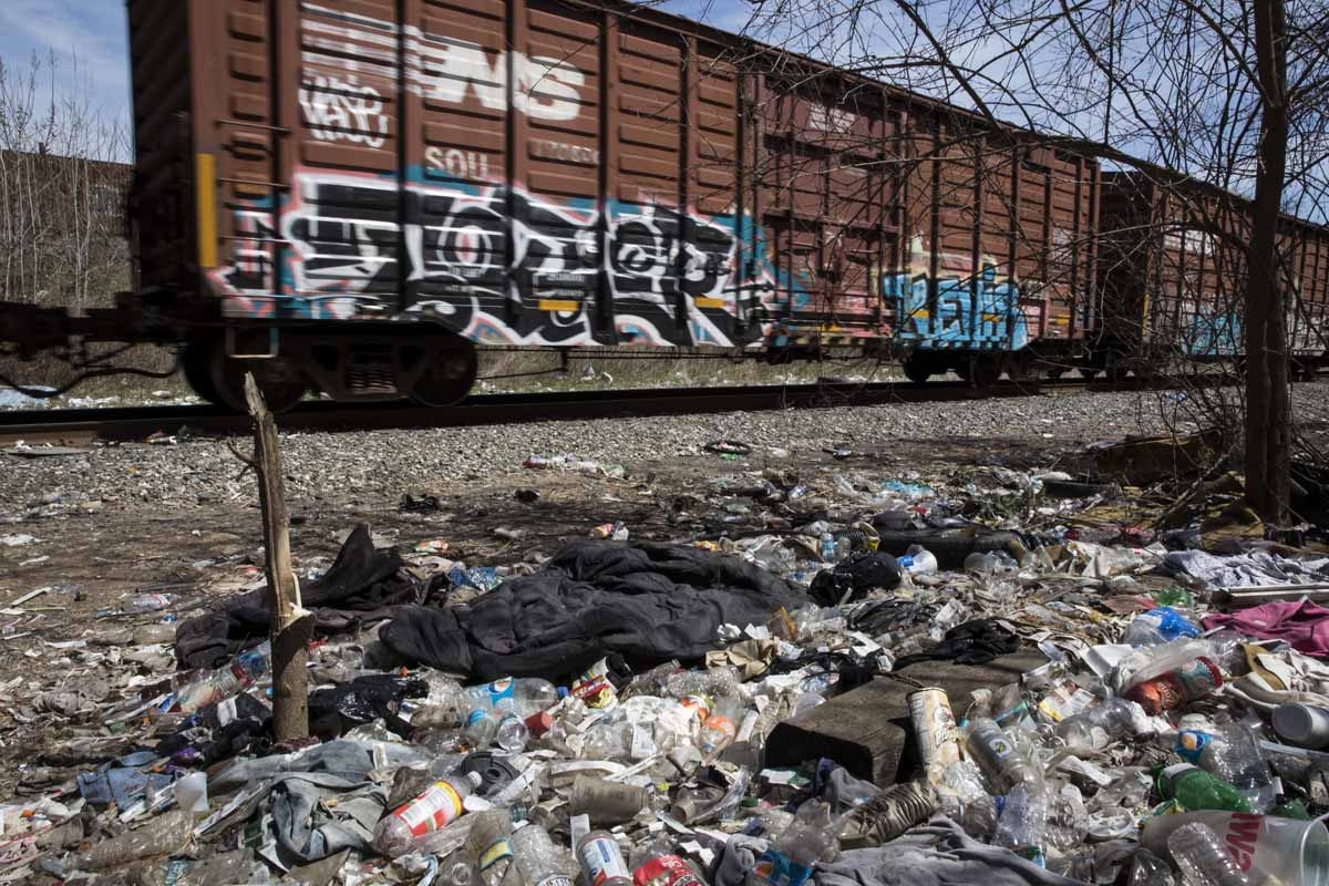 Freight cars rumble past a heroin encampment in the Kensington neighborhood of Philadelphia, Pennsylvania, on April 10, 2017.