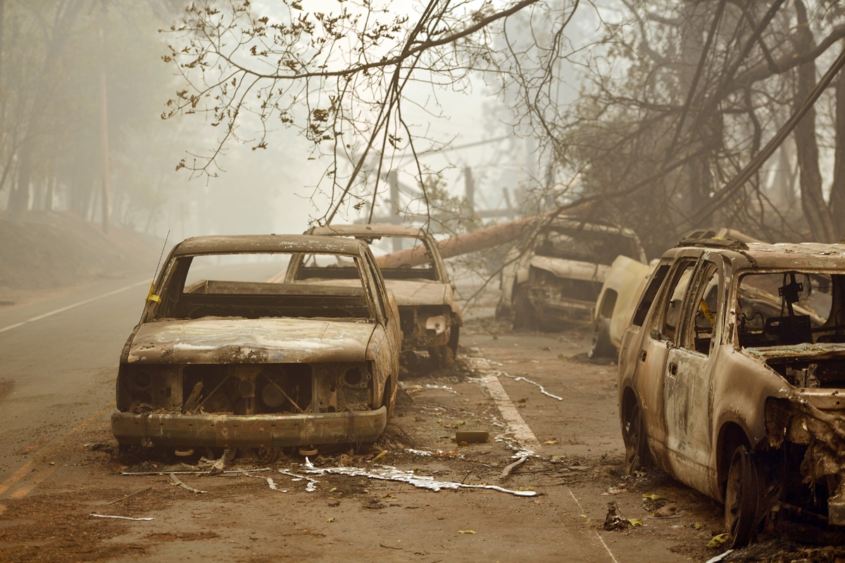 Burnt out vehicles are seen on the side of the road in Paradise, California after the Camp fire tore through the area on November 10, 2018.