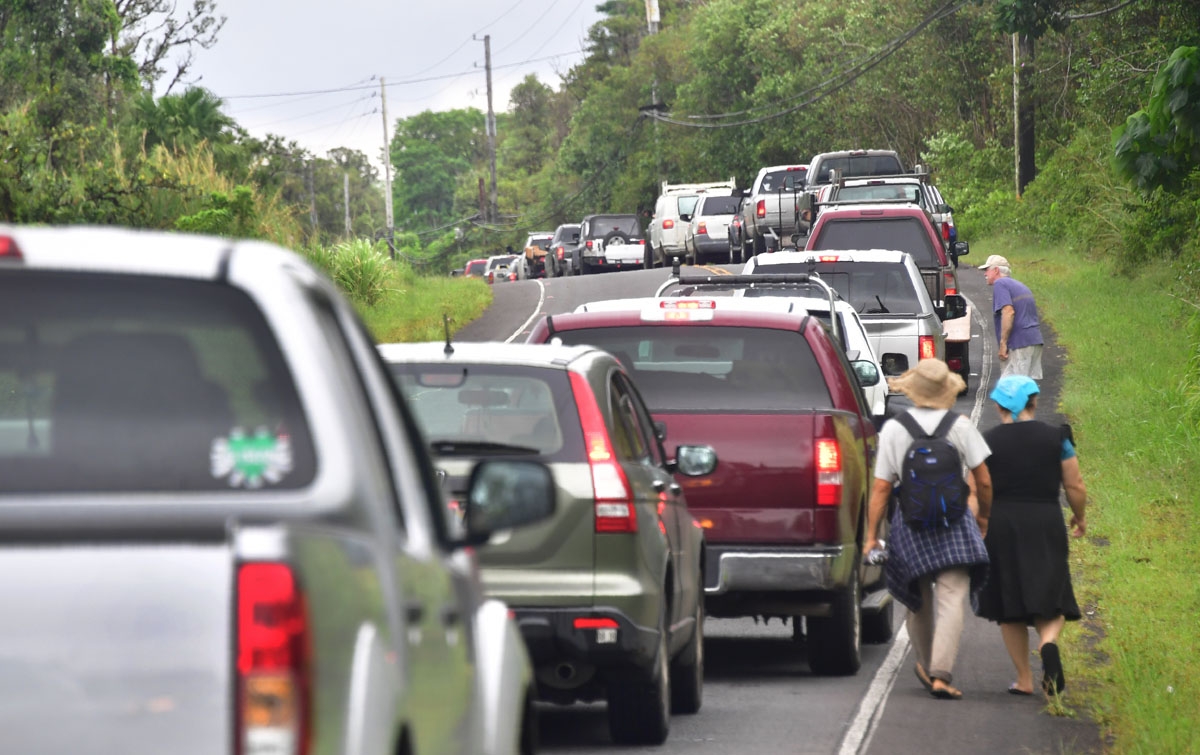 A convoy of vehicles of Leilani Estates residents waits to be let back into their homes to gather belongings on May 7, 2018. The residents were forced to evacuate a few days earlier because of Kilauea fissures.